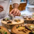 chefs preparing foods on tree slabs